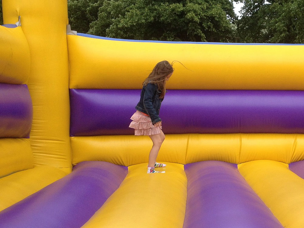girl bouncing in an inflatable bounce castle