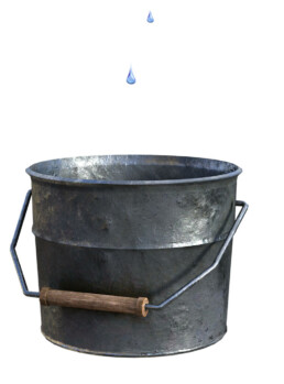 bucket with two drops of water falling into it