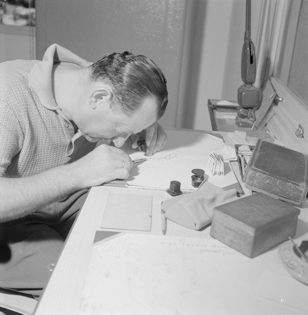 black and white photo of a jeweler looking through a loupe